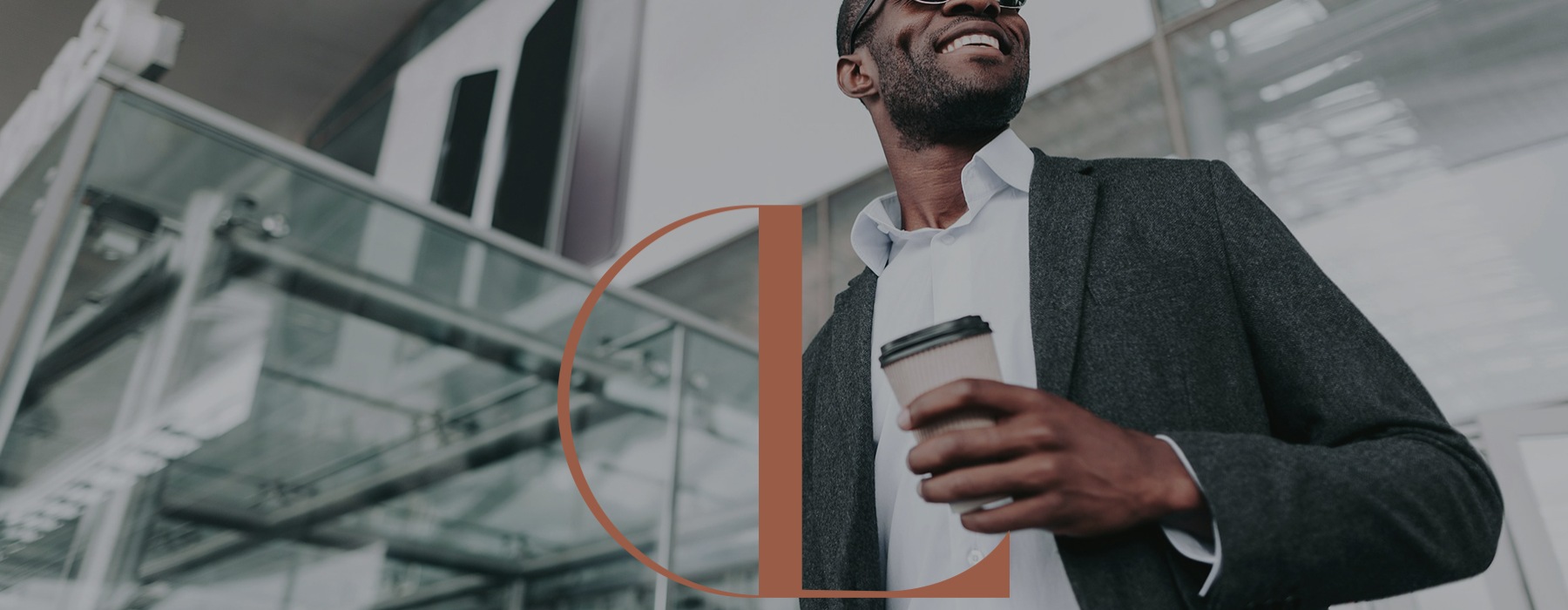 a man with his coffee cup in a city environment