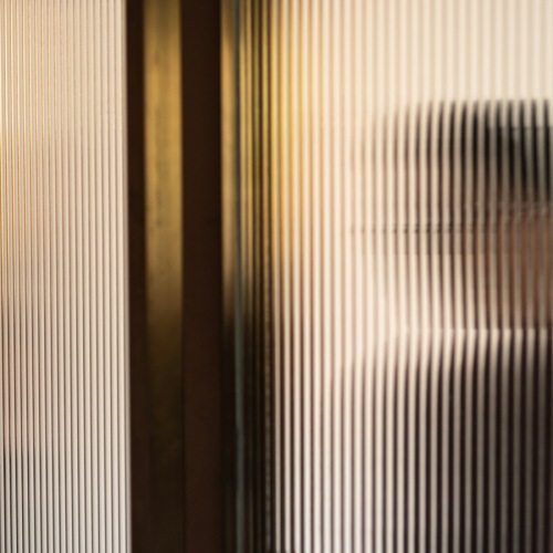 rippled glass and a person standing